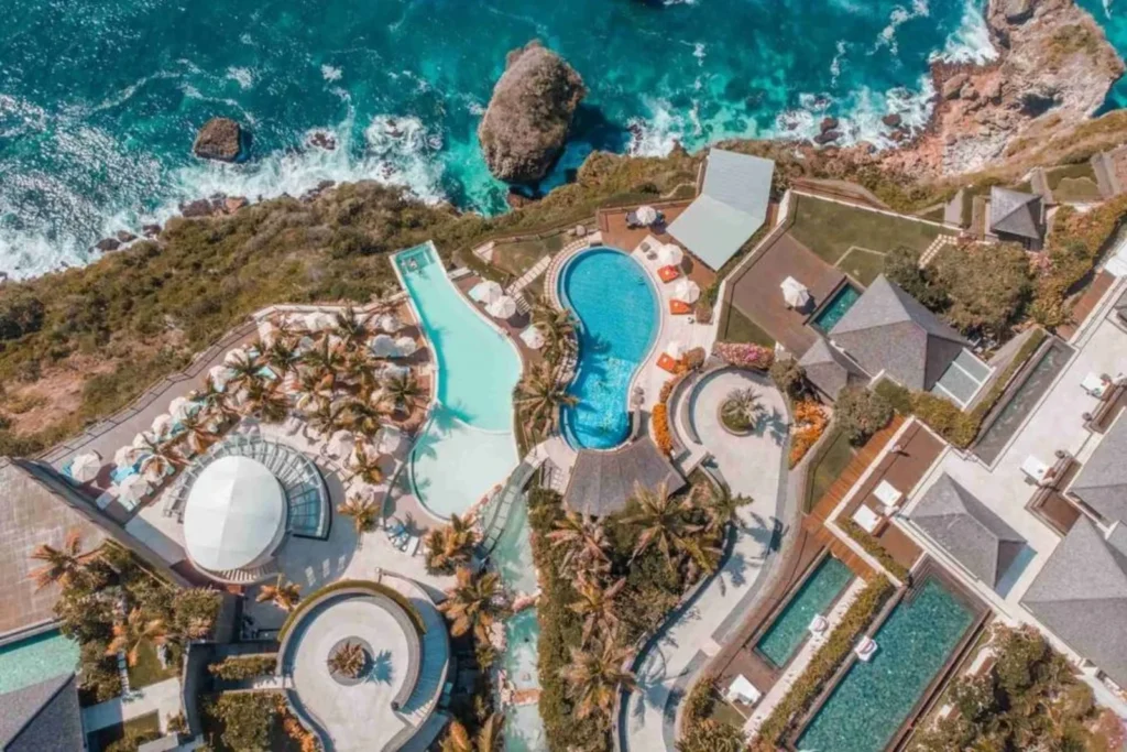 Aerial view of the Oneeighty cliff-edge infinity pool and luxury resort in Uluwatu, Bali.