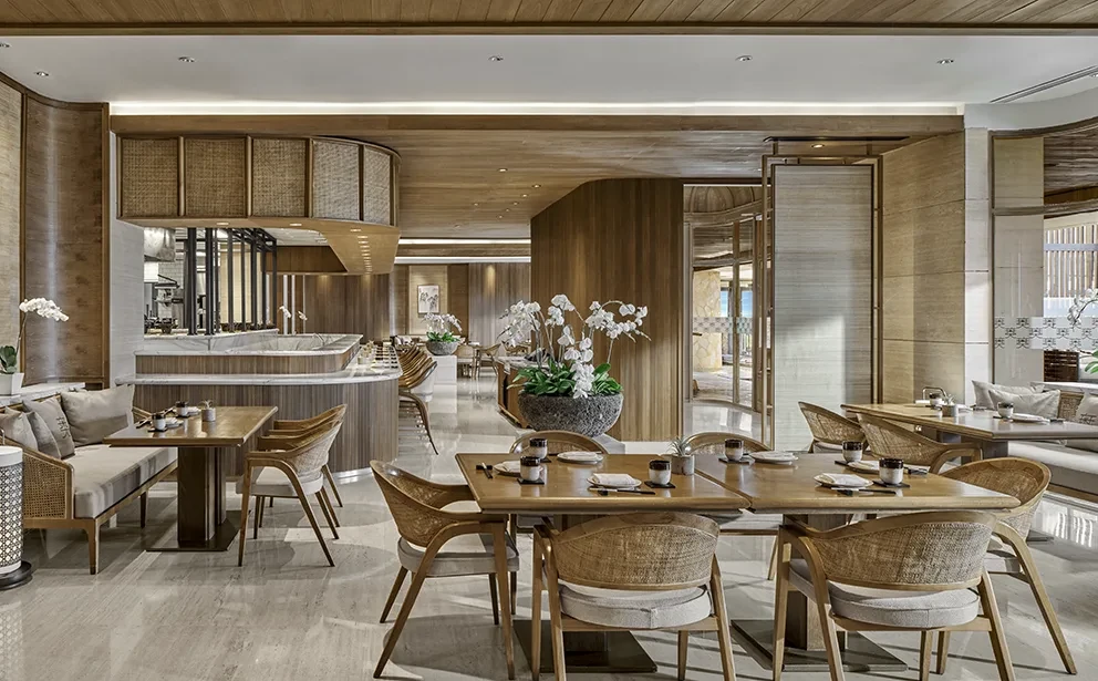 Modern restaurant interior with wooden décor and orchid plants.